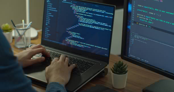 Closeup coding on screen, Man hands coding html and programming on two screen Monitors, development web, developer
